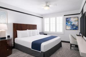 a hotel room with a bed and a desk at Tilden Hotel Union Square in San Francisco