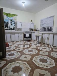 a kitchen with a large tile floor in a kitchen at Palm Breeze Villa in Green Island