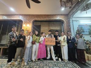 a group of people posing for a picture with a sign at Tâm Family Homestay-Huế in Hue +78 photos