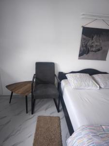 a room with a bed and a chair and a table at Modern lux studio B in Beringen