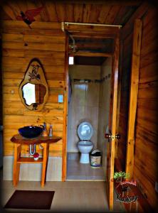 a bathroom with a toilet and a sink at Cabañas Sumak Kawsay in Colón +13 photos