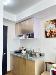 a kitchen with a sink and a counter top at Convenient Condo - Nearby CDO Mall in Pontud