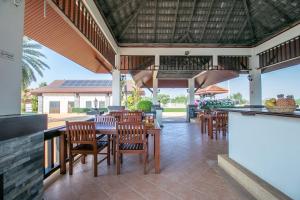 a patio with a table and chairs and a bar at SeaBreeze Residence Mae Phim in Ban Tha Fat