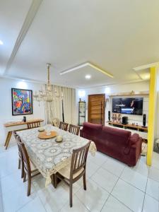 a living room with a table and a couch at 4 quartos na Folia de Olinda in Olinda