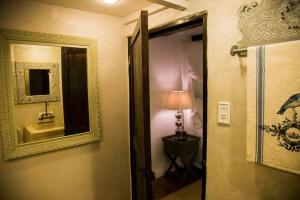 a bathroom with a mirror and a sink and a lamp at Reserva Monte Sagrado 1 in Utuado +40 photos