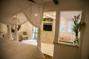 a bedroom with a bed and a living room at Reserva Monte Sagrado 1 in Utuado