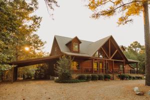 a log home with a metal roof at Heated Pool, 7 Bedroom Cabin, 6,000 Square Feet, Arcade! in Broken Bow