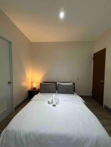 a large white bed with a stuffed animal on it at Ashelma resort in Dauis +6 photos