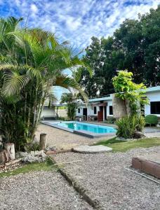 a house with a swimming pool in a yard at Ashelma resort in Dauis