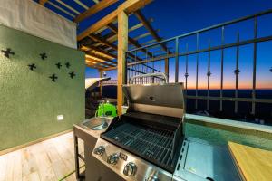 a grill on a balcony with a view of the ocean at Tzfat Regal - צפת ריגל in Safed
