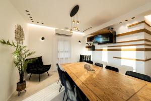 a dining room with a wooden table and chairs at Tzfat Regal - צפת ריגל in Safed
