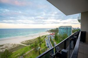 a view of the beach from the balcony of a condo at Iconic Kirra Beach Resort in Gold Coast