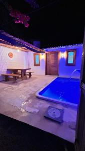 a swimming pool in a backyard at night at Casa Sophi in Cruz