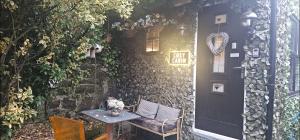 a table and chair in front of a door at BELFAST COSY CABIN in Belfast