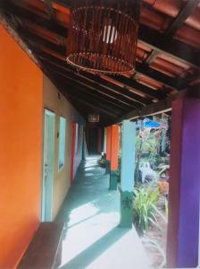 a hallway of a building with colorful walls and a ceiling at EsPAÇO RUSTIK in Santa Cruz Cabrália