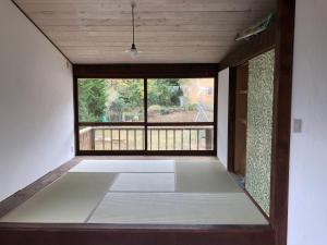 an empty room with a large window in a house at Emeraldia in Tateyama
