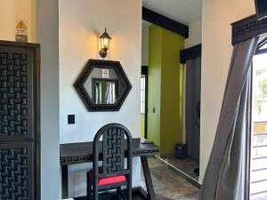 a hallway with a mirror and a chair at Hotel Villa's Camargo in Ixmiquilpan
