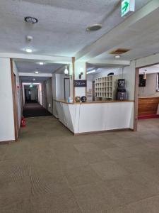 an empty lobby with a counter in a building at Sanso On Snow in Nagano +3 photos