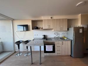 a kitchen with a counter and a refrigerator at Genesis in Chillán