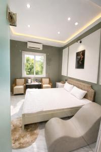 a bedroom with a large bed and a couch at Phước Hưng 1 Hotel in Vĩnh Long