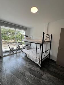 a bedroom with a bunk bed and a window at Alma del Mar in Volcán Chimborazo +22 photos
