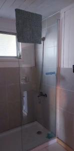 a bathroom with a shower with a glass door at Cabaña Chango in Coquimbo +17 photos