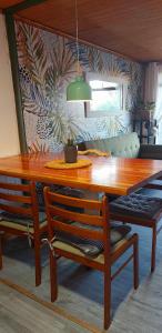 a dining room with a wooden table and two chairs at Cabaña Chango in Coquimbo