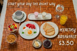a breakfast table with breakfast foods and drinks on it at Colonial House Inn in Quito