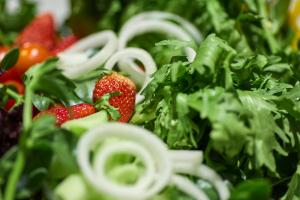 a salad with strawberries and lettuce and broccoli at Mercure Beijing City Center in Beijing