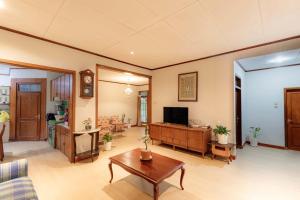 a living room with a couch and a table at Imah Budi Luhur in Bandung
