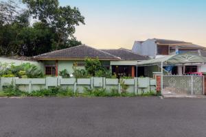 a house with a fence in front of it at Imah Budi Luhur in Bandung