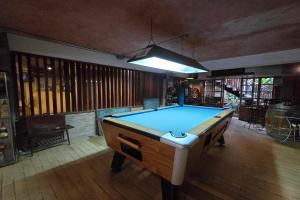 a pool table in the middle of a room at P1 House Phitsanulok in Phitsanulok