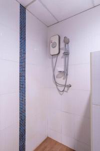 a shower in a white bathroom with a hose at P1 House Phitsanulok in Phitsanulok +40 photos