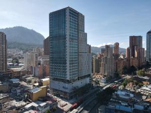 a tall glass building in the middle of a city at Aparta Suite Centro Internacional Edificio 33DC Piso 29 Estación Trasmilenio Calle 34 in Bogotá