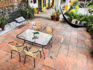 a patio with a table and chairs and a hammock at Shanti Home in Tepoztlán +40 photos