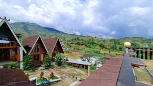 a view of a house with a mountain in the background at Zaada Villa Dieng Syariah By Travelink in Kejajar