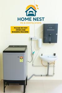 a water heater in a bathroom with a sink at Home Nest in Anand