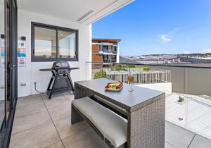 a balcony with a table and a meal on it at Aqua Cove - Marina Escape in Shellharbour