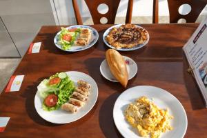 a wooden table with plates of food on it at Chi Thanh Villa in Hoi An +56 photos