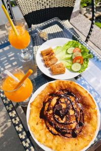 a table with two plates of food and some drinks at Chi Thanh Villa in Hoi An