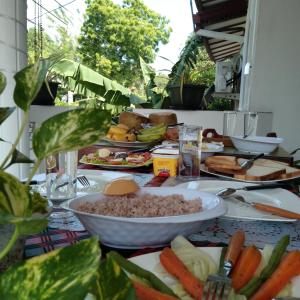 a table with a bowl of rice and vegetables on it at Dream Villa in Batigama