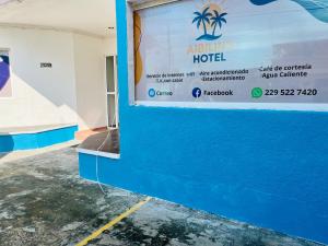 a sign for a hotel on the side of a building at Aibilins in Veracruz