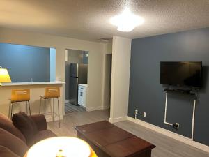 a living room with a couch and a kitchen at Rimbey Motor Inn in Rimbey