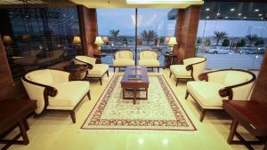 a waiting room with chairs and a table and a rug at Rabigh Park Hotel in Rabigh