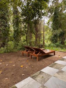 a wooden picnic table in a park under a tree at Lakehouse in the Old Rainforest in Ko Phangan