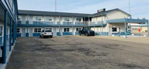 a parking lot in front of a large building at Rimbey Motor Inn in Rimbey