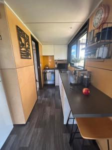 a kitchen with a counter and a clock on the wall at Gorgeous private tiny home in  Waipukurau