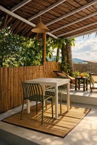 a white table and chairs on a patio at Little Mountain Nest in Haad Pleayleam