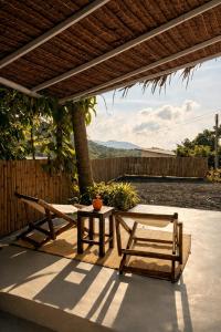 a patio with two chairs and a table and a fence at Little Mountain Nest in Haad Pleayleam +8 photos