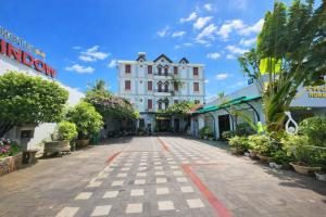 a street in a town with buildings and plants at Window 2 Hotel in Kon Tum